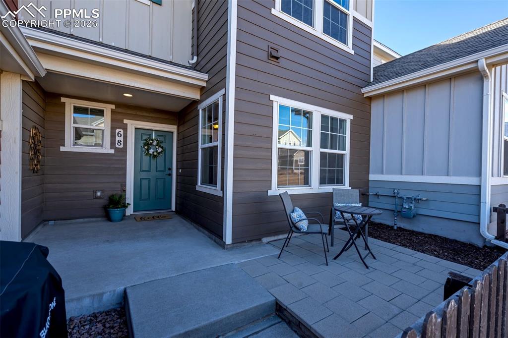 Image 4 of 48: This shows the patio and front door of the townhome.