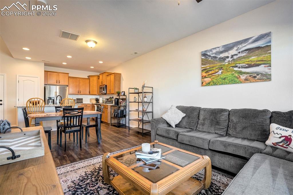 Image 8 of 48: Living area showing the true open floor plan looking to the dining and kitc