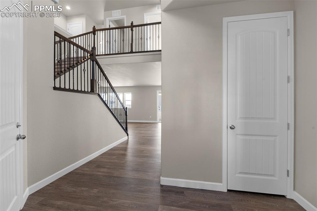 Image 3 of 13: Staircase featuring baseboards, recessed lighting, wood finished floors, an