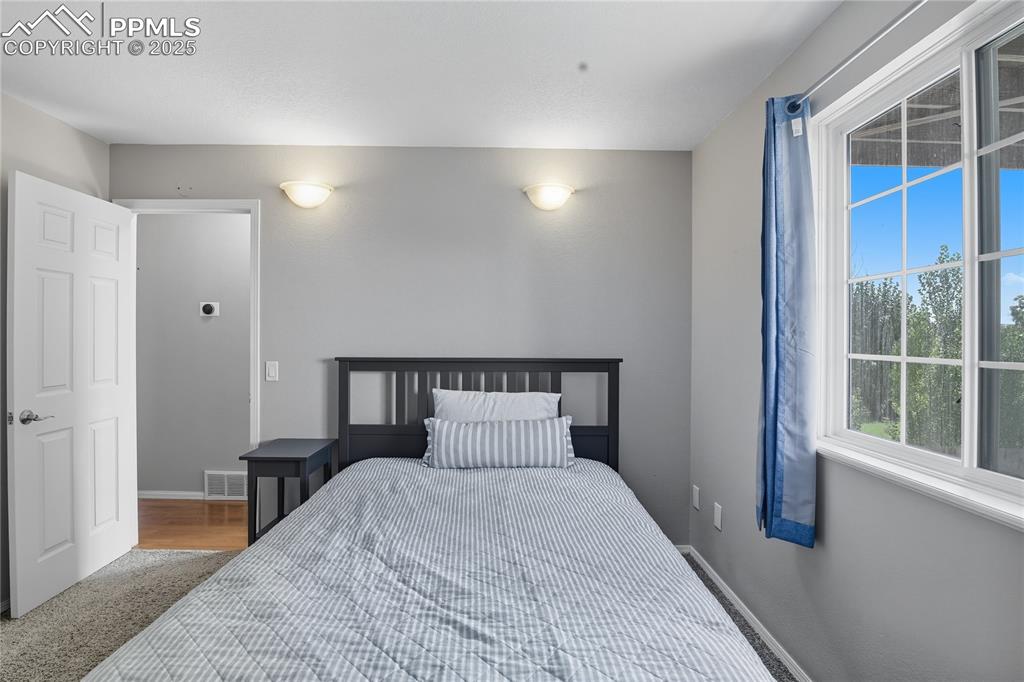 Image 14 of 32: Bedroom with baseboards and carpet