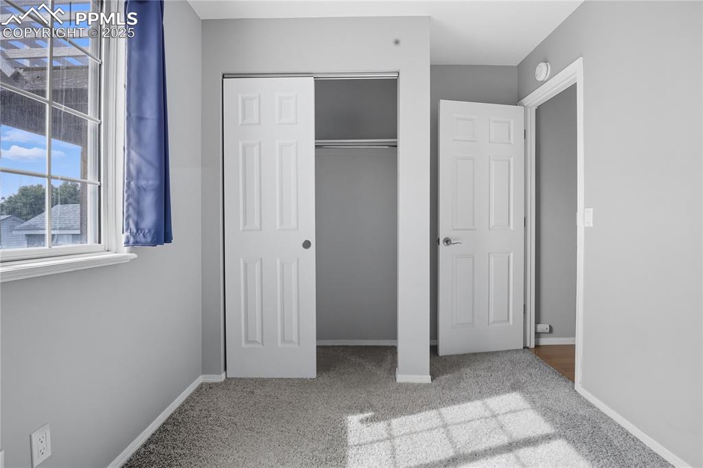 Image 17 of 32: Unfurnished bedroom with light colored carpet and a closet