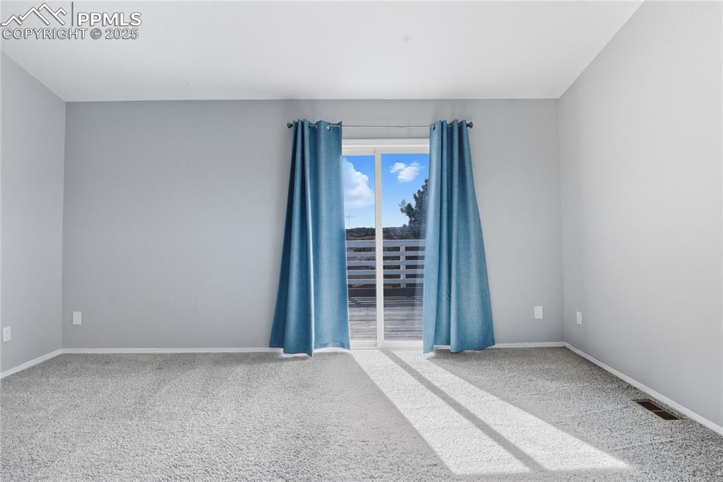 Image 18 of 32: Carpeted empty room with baseboards