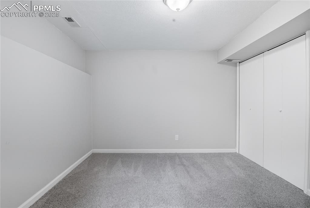 Image 28 of 32: Unfurnished bedroom featuring carpet flooring and a closet