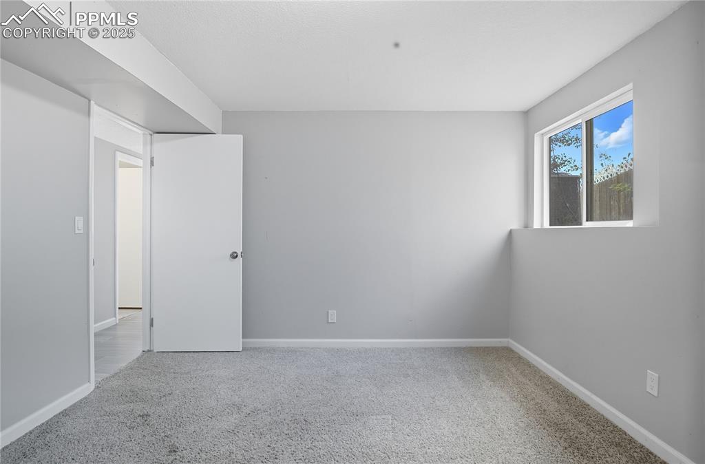 Image 29 of 32: Unfurnished room featuring light colored carpet and baseboards