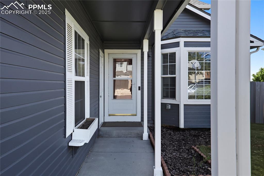Image 3 of 32: Entrance to property featuring covered porch