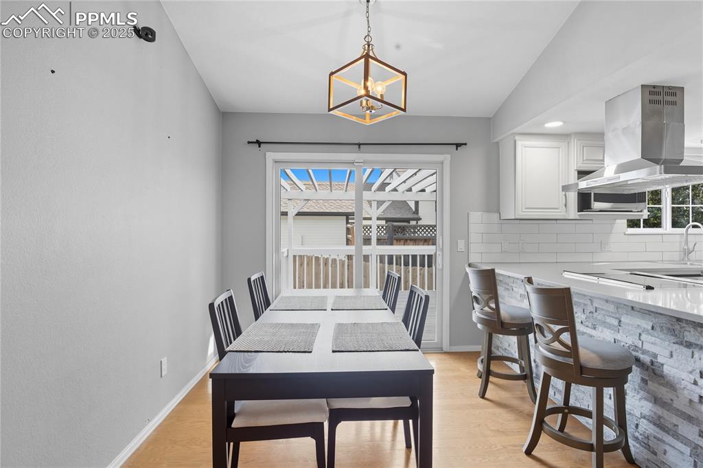 Image 5 of 32: Dining room featuring light wood-type flooring and lofted ceiling
