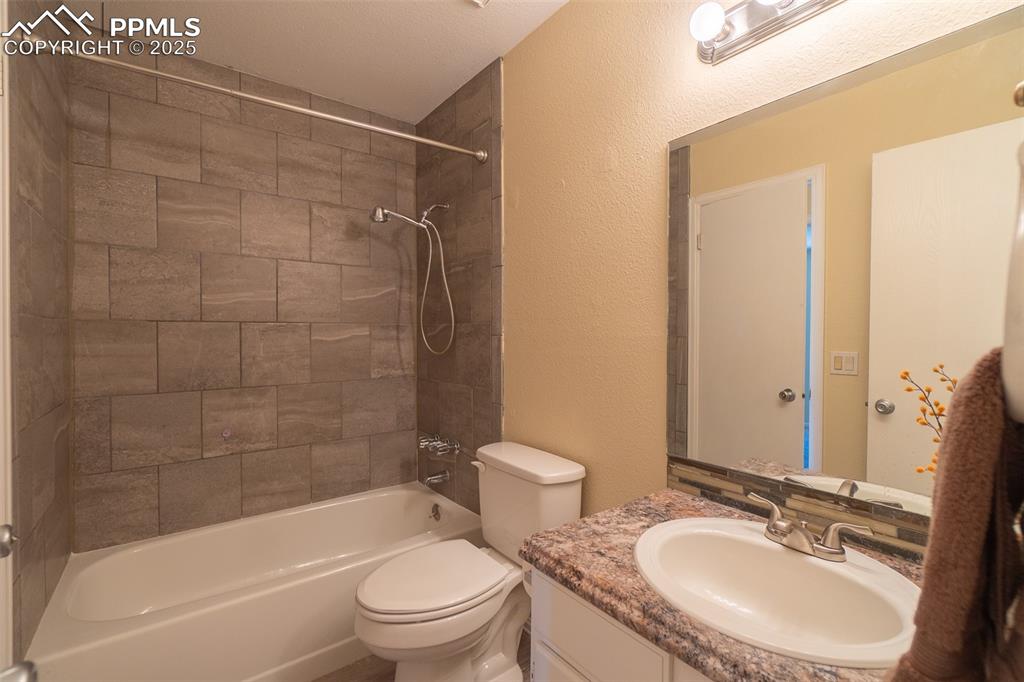 Image 21 of 42: Master bathroom with a 2nd door to the hallway on the upper level.  Feature