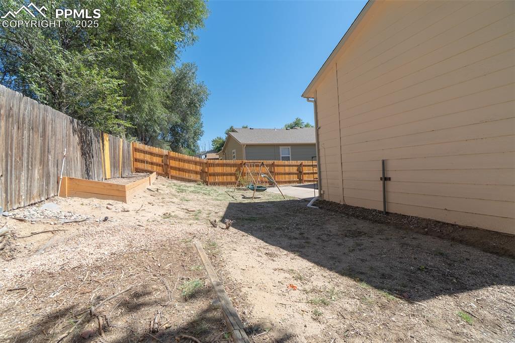 Image 35 of 42: View of fenced backyard