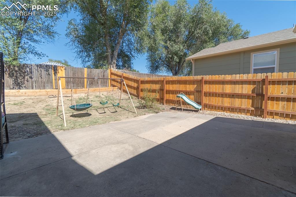 Image 36 of 42: Fenced backyard featuring a patio area