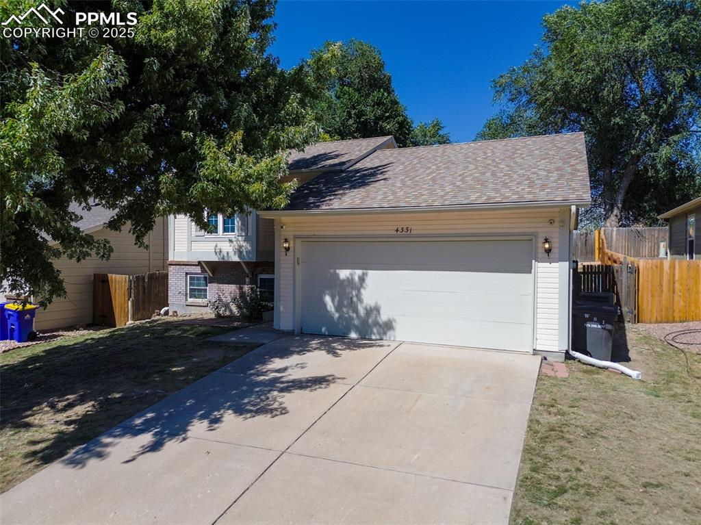 Image 41 of 42: View of front of home featuring brick siding, concrete driveway, an attache