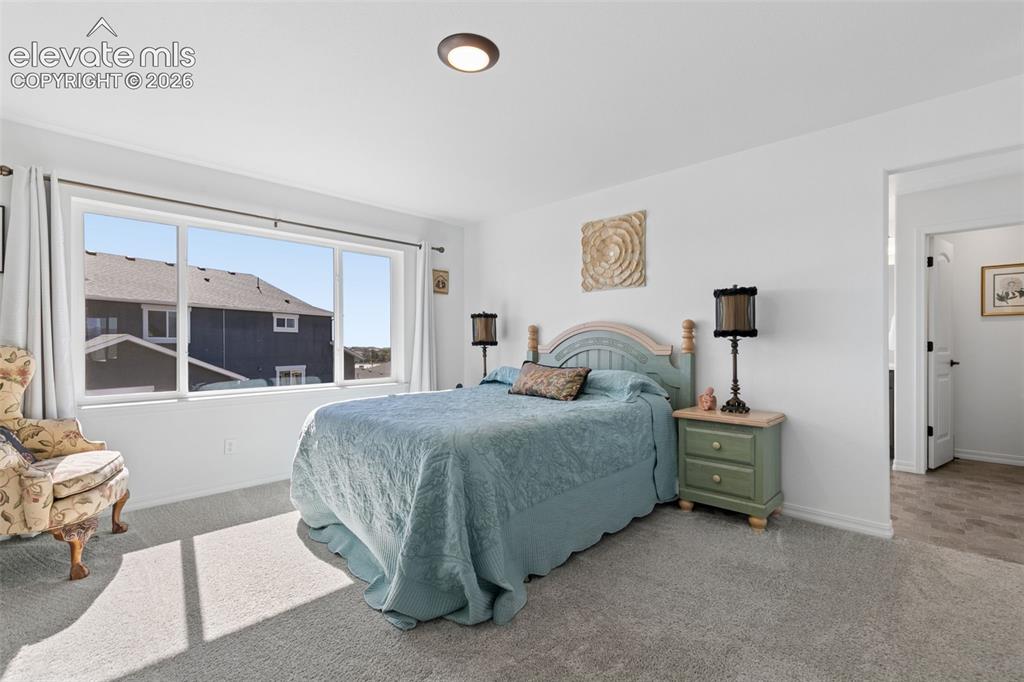 Image 11 of 26: White walls, a large window, recessed ceiling lighting, and carpet flooring