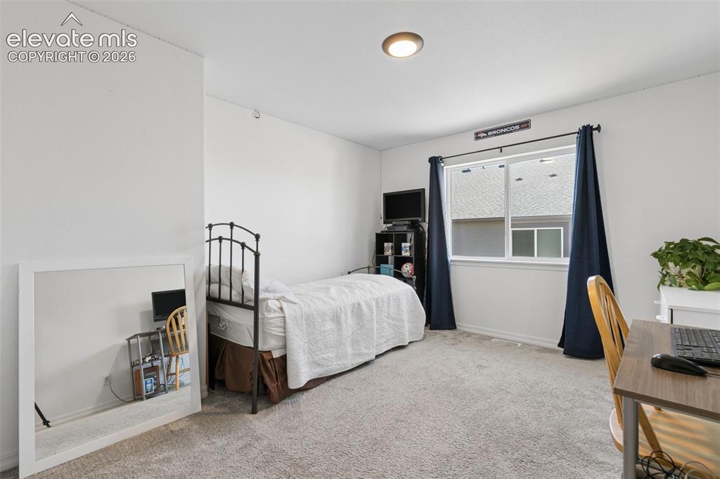 Image 17 of 26: Carpeted flooring, recessed ceiling lighting, and a window with blinds