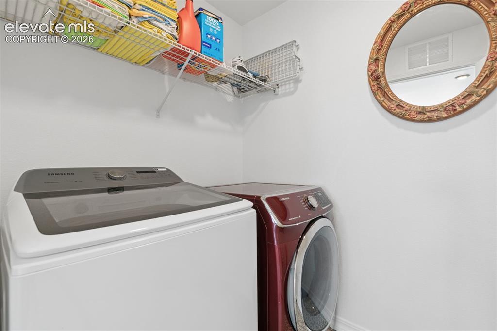 Image 19 of 26: White walls with a single wire storage shelf