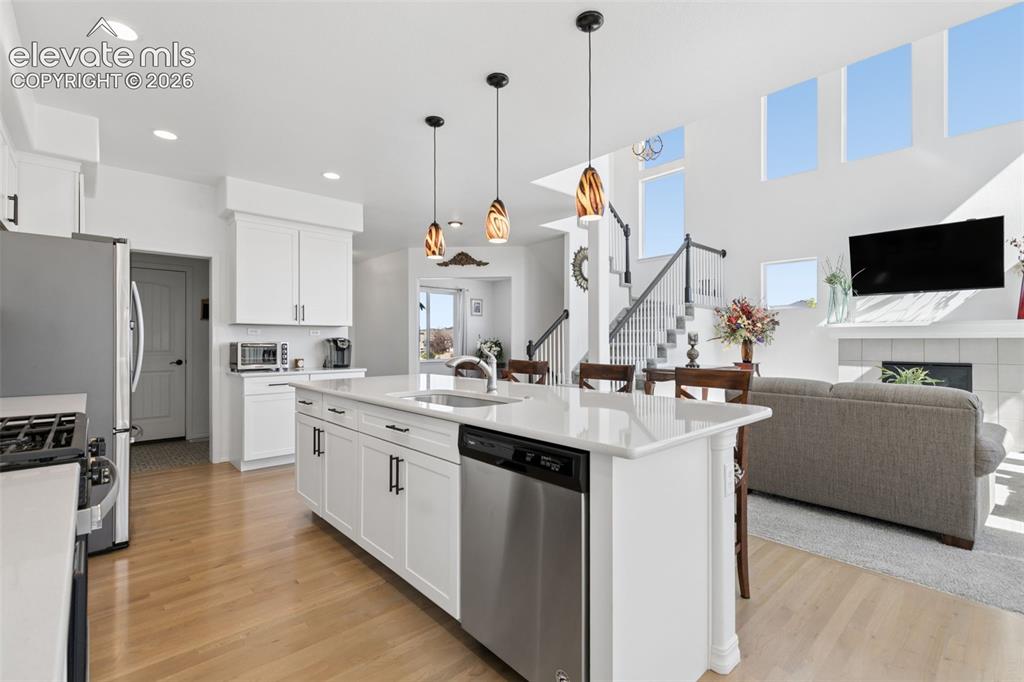 Image 7 of 26: Kitchen island with a built-in stainless steel dishwasher, a single basin s