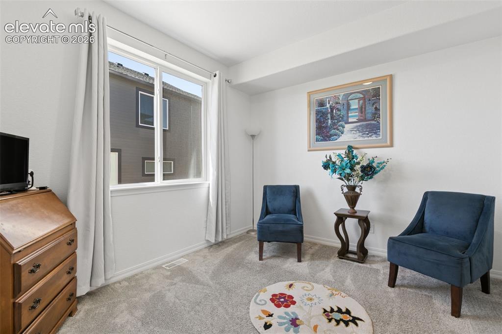 Image 9 of 26: Expansive window with white trim, light gray carpet flooring, and neutral w