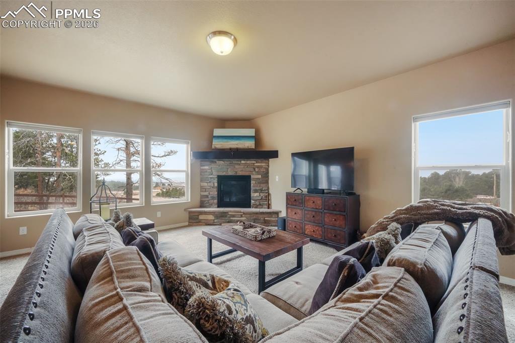Image 16 of 50: Open concept living room with mountain views, natural light and gas firepla