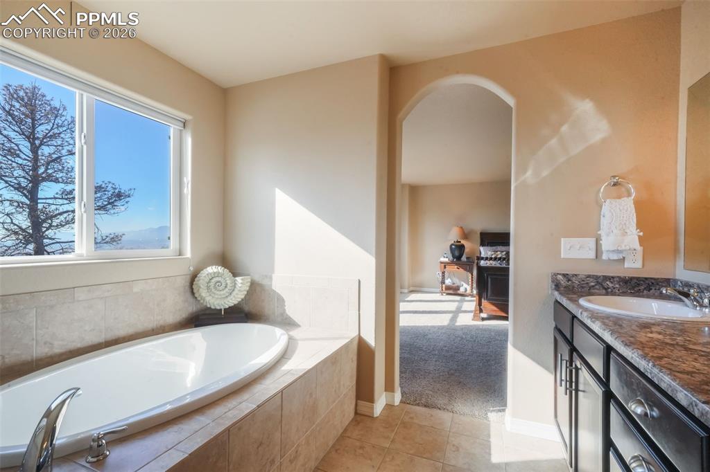 Image 27 of 50: Primary bathroom with dual vanities, soaking tub, large shower, and walk in