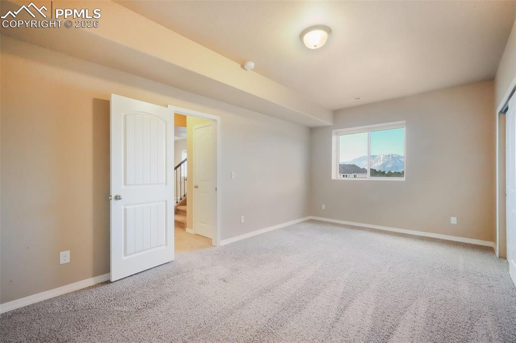 Image 43 of 50: Basement fifth bedroom with mountain views and walk in closet