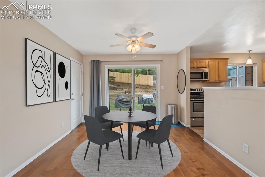 Image 10 of 40: Dining area featuring light wood finished floors and ceiling fan. virtually