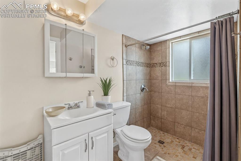 Image 18 of 40: Full bath with vanity and a shower stall. virtually staged