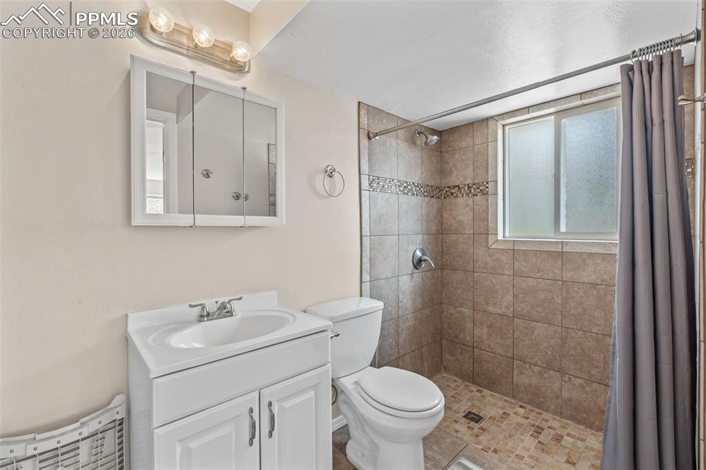 Image 19 of 40: Bathroom featuring vanity and a shower stall