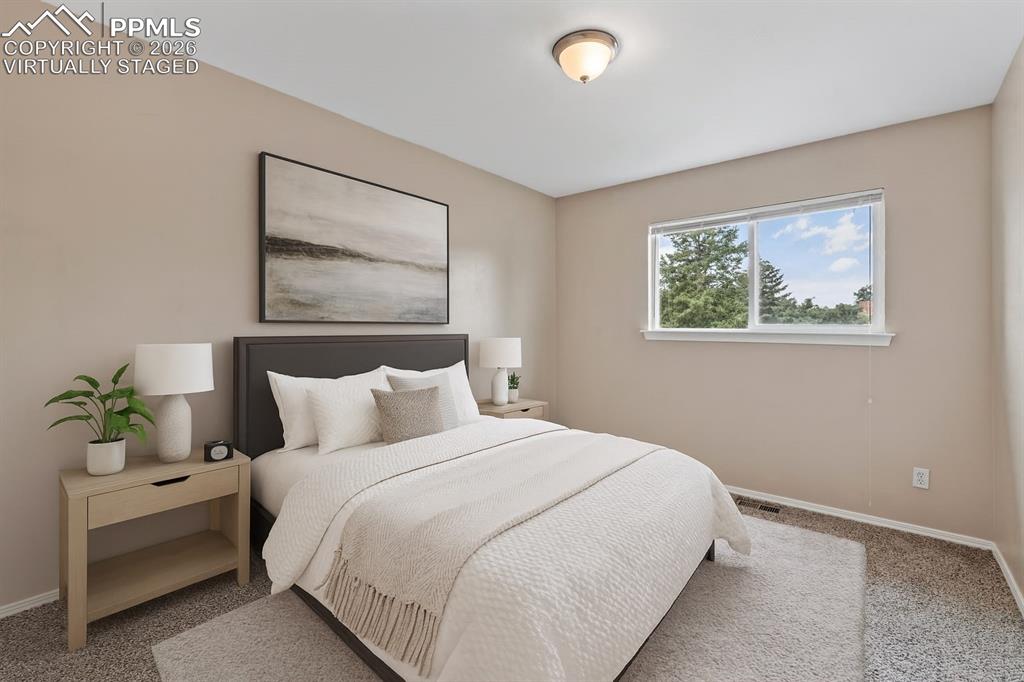 Image 20 of 40: Bedroom with carpet flooring and baseboards. virtually staged