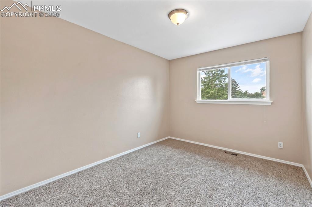 Image 21 of 40: Empty room with carpet floors and baseboards