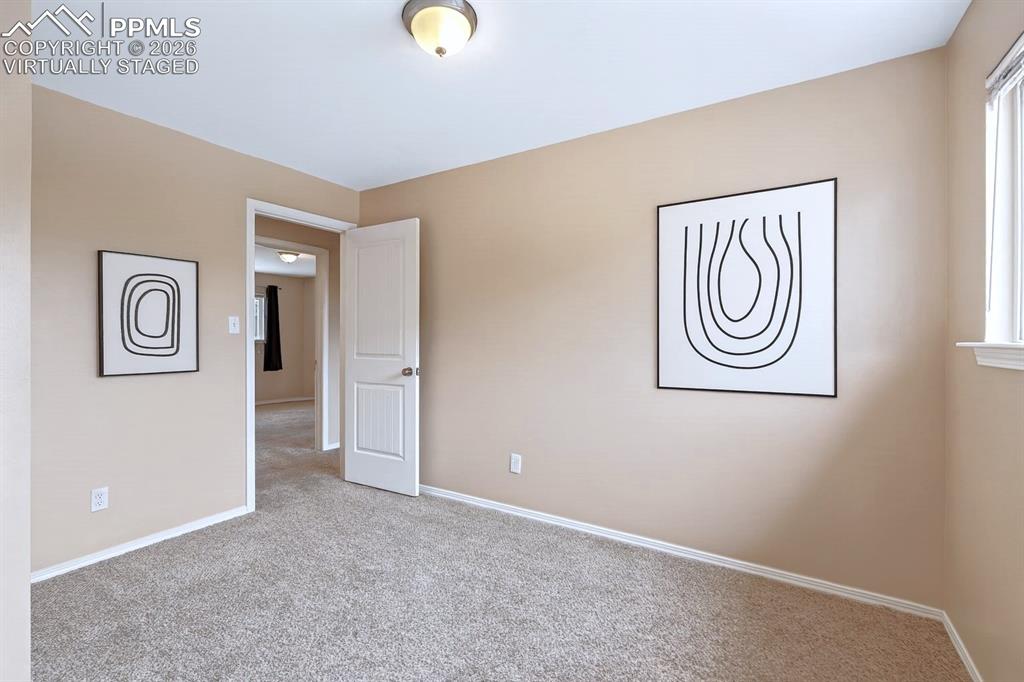Image 26 of 40: Unfurnished bedroom featuring baseboards and carpet. virtually staged
