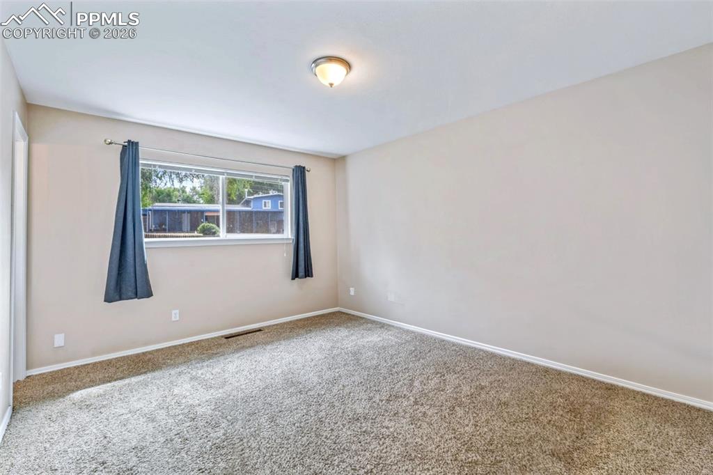 Image 31 of 40: Carpeted empty room with baseboards