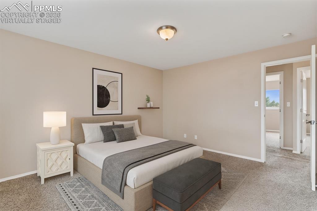 Image 32 of 40: Bedroom with light carpet and baseboards. virtually staged