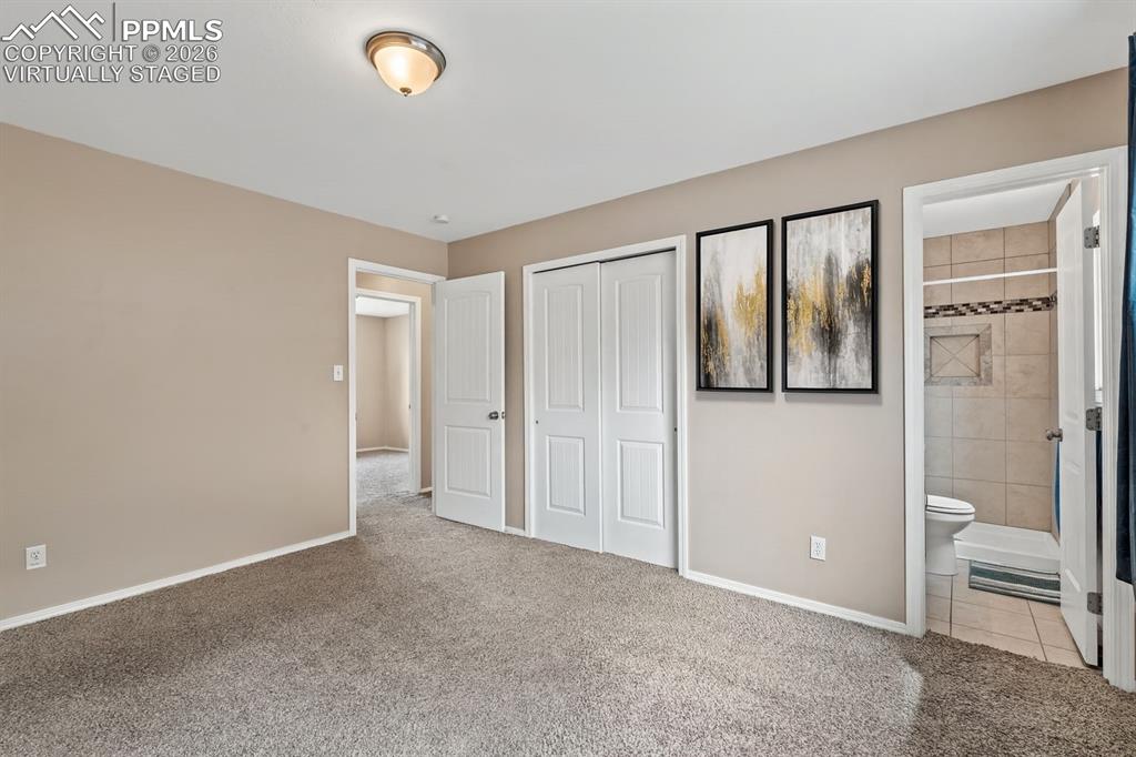 Image 34 of 40: Unfurnished bedroom with light carpet, a closet, and ensuite bathroom. virt