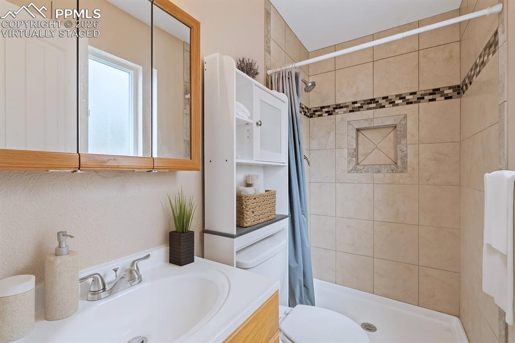 Image 36 of 40: Bathroom with vanity and a shower stall. virtually staged
