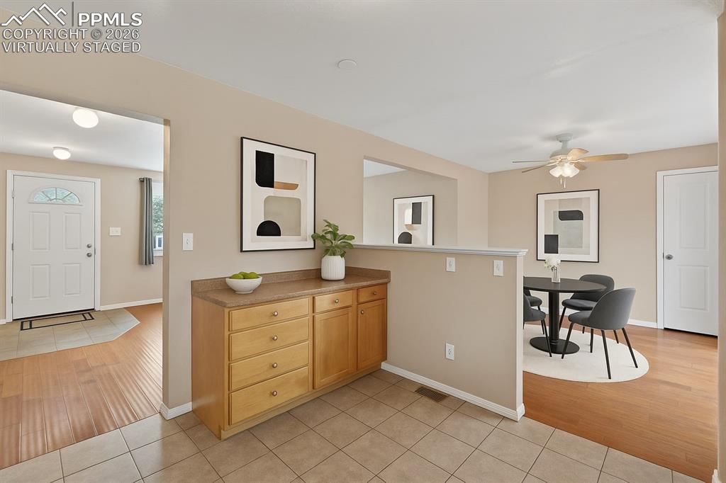 Image 6 of 40: Foyer featuring light tile patterned floors and ceiling fan. virtually stag