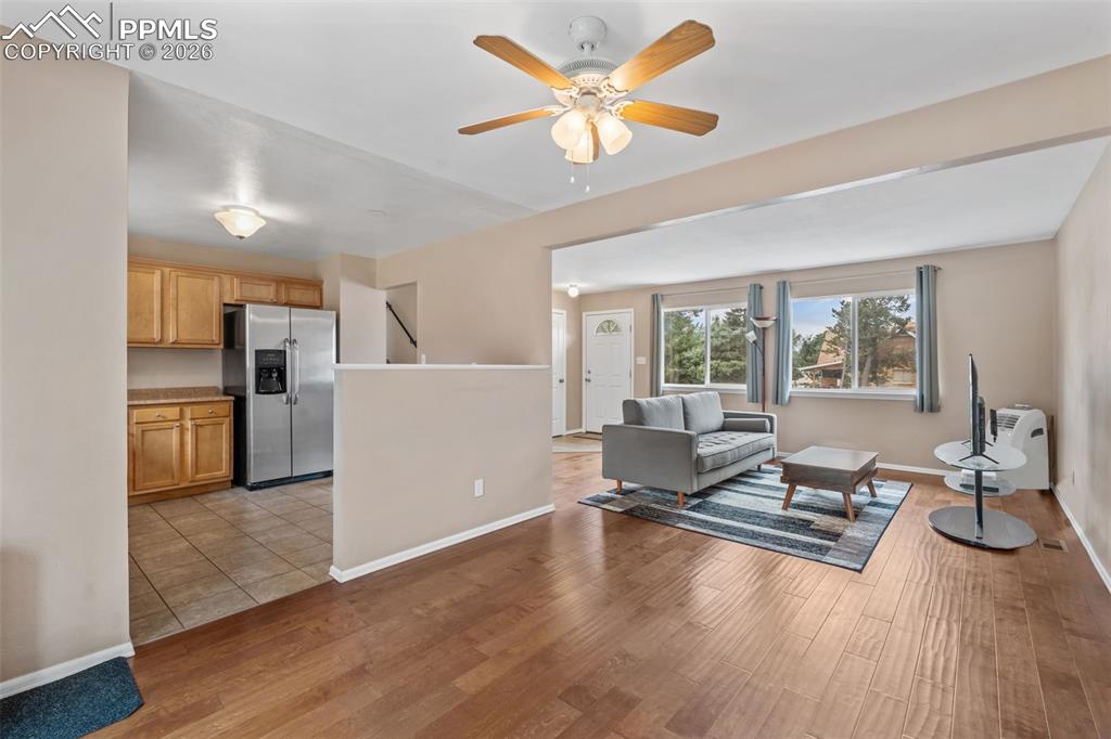 Image 9 of 40: Living area featuring a ceiling fan and light wood-type flooring