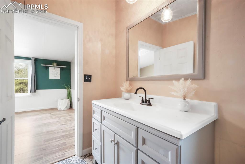 Image 28 of 50: Bathroom featuring vanity and light wood-style floors
