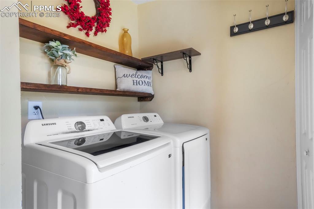 Image 38 of 50: Laundry area with washer and clothes dryer
