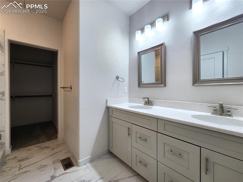 Image 17 of 31: Primary bathroom with closet at the end