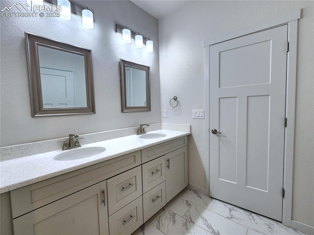 Image 18 of 31: Modern double vanity with plenty of cabinets