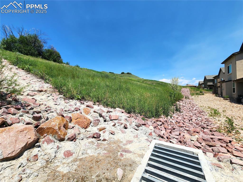 Image 29 of 31: Open hillside area behind the home