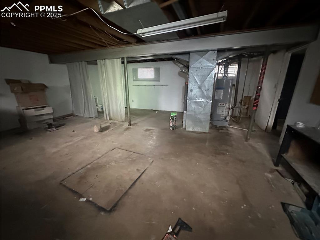 Image 12 of 14: Below grade area with gas water heater