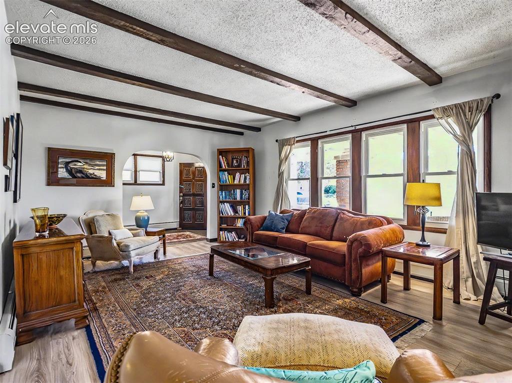 Image 2 of 27: With Fireplace, Built-Ins and spacious entry off of screened porch.