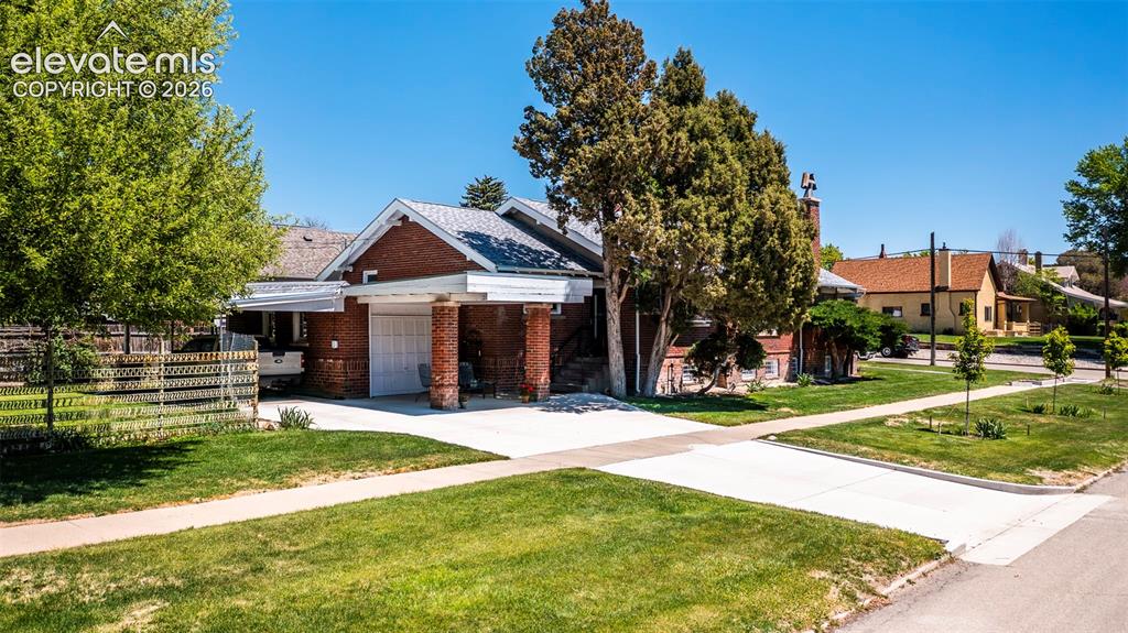 Image 26 of 27: Brick exterior featuring a gabled roof and attached 1 car garage