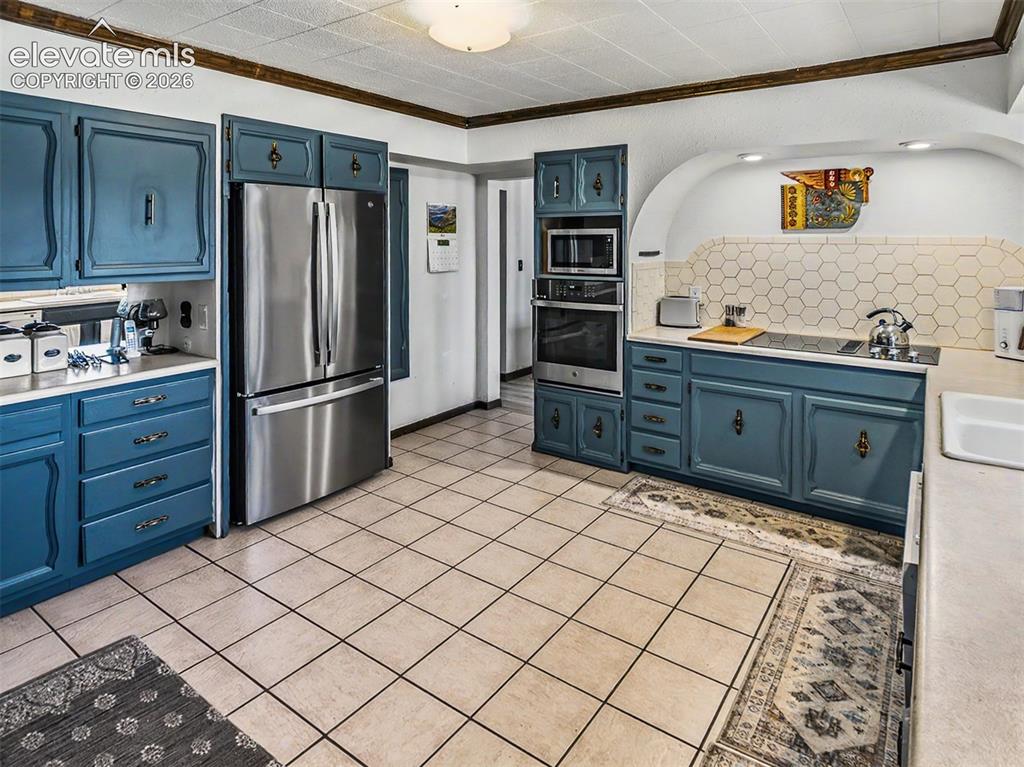 Image 7 of 27: Stainless Steel appliances include a drop in glass cooktop.
