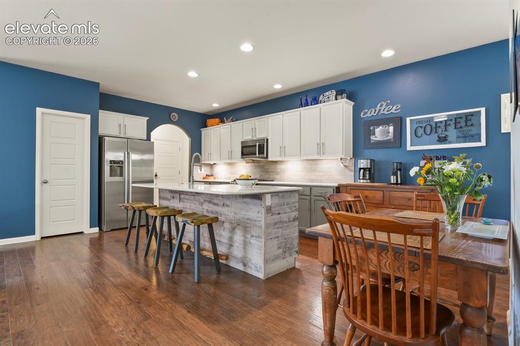 Image 11 of 47: Bar height kitchen for additional seating.