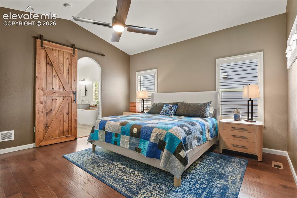 Image 21 of 47: Custom barn door heading into the primary bathroom.