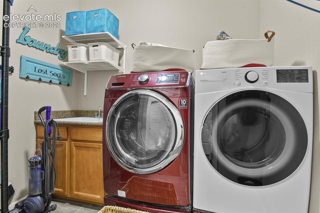 Image 27 of 47: Laundry room with utility sink.