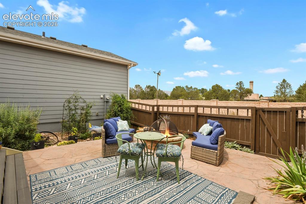 Image 41 of 47: Professionally landscaped back yard with stamped concrete patio.