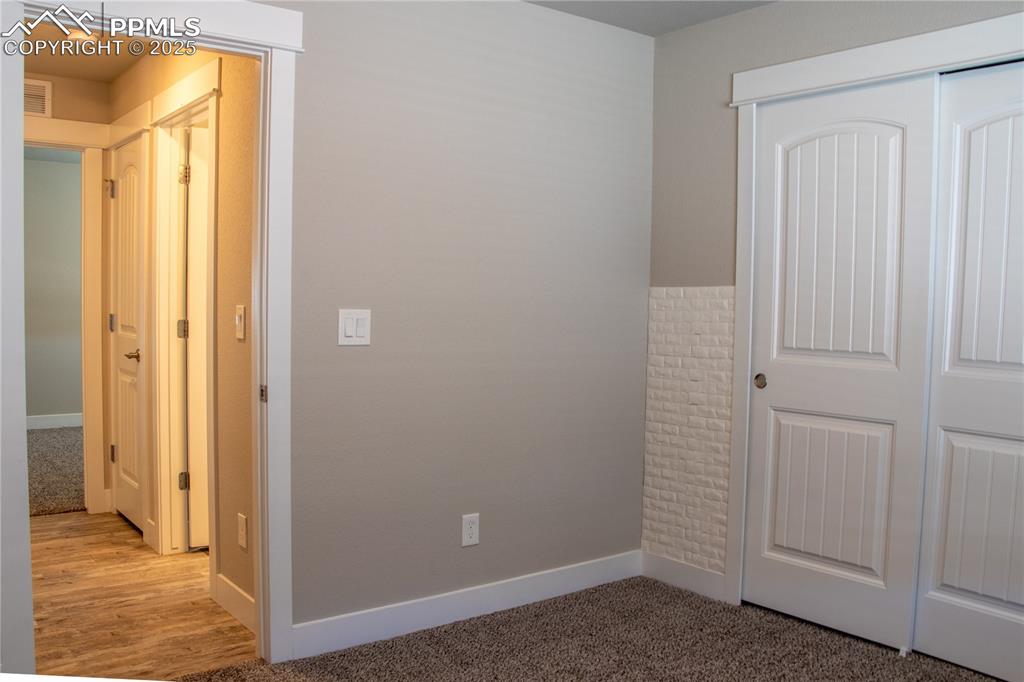 Image 22 of 30: Unfurnished bedroom featuring a closet and carpet flooring