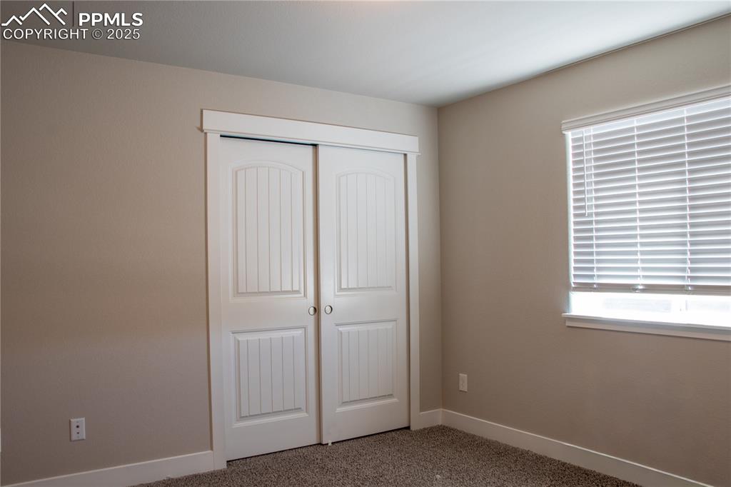 Image 23 of 30: Unfurnished bedroom with carpet flooring and a closet