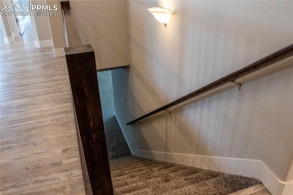 Image 24 of 30: Stairway featuring carpet flooring